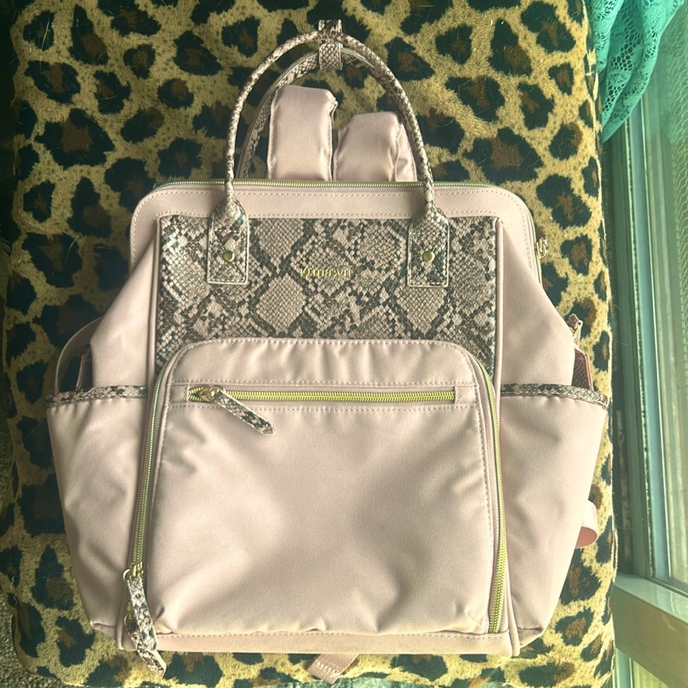 Dusky pink small backpack.   Many pockets with zipper close. 13 x 13